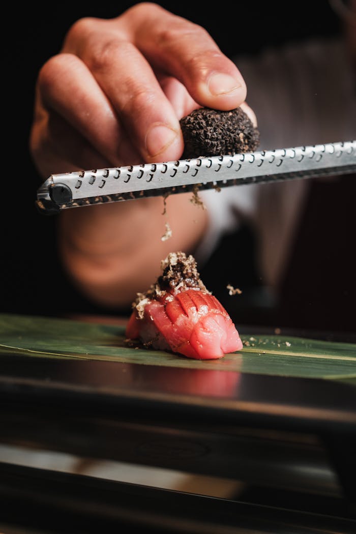Expertly prepared nigiri sushi topped with freshly grated truffle, offering a fusion of flavors.